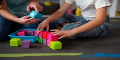 psychologist-helping-little-girl-speech-therapy-indoors.jpg