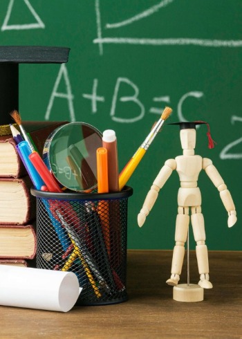 front-view-wooden-figurine-with-academic-cap-books.jpg